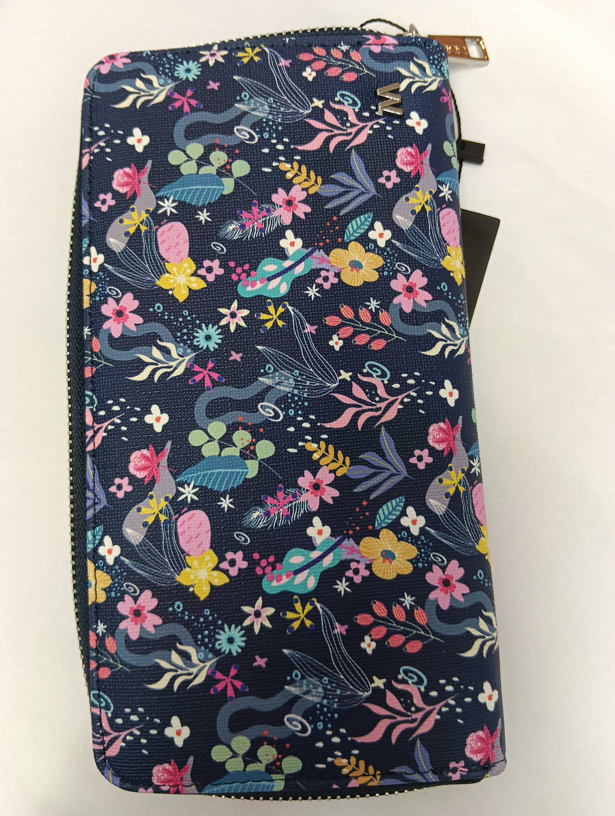 Monedero con tejido estampado floral,con fondo azul oscuro y motivos de flores y hojas de varios colores